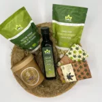hemp discovery pack with products arranged in a basket on a wooden table. Hemp oil, raw hemp seeds, shelled hemp seeds, hemp protein powder, milk chocolate and dark chocolate with hemp seeds.